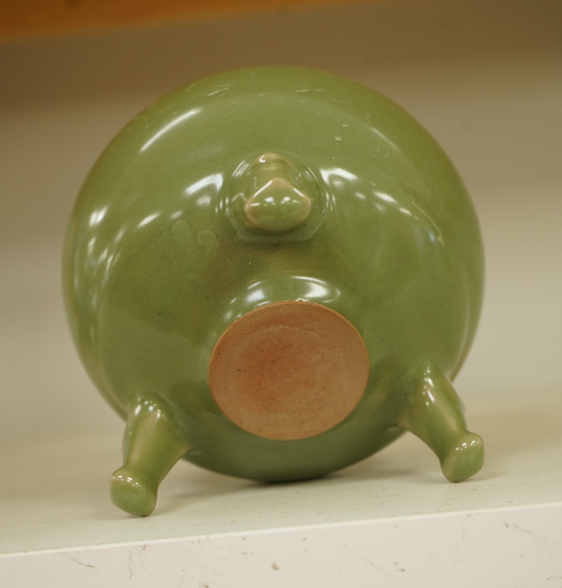 A Chinese green glazed censor on tripod feet, 16cm high